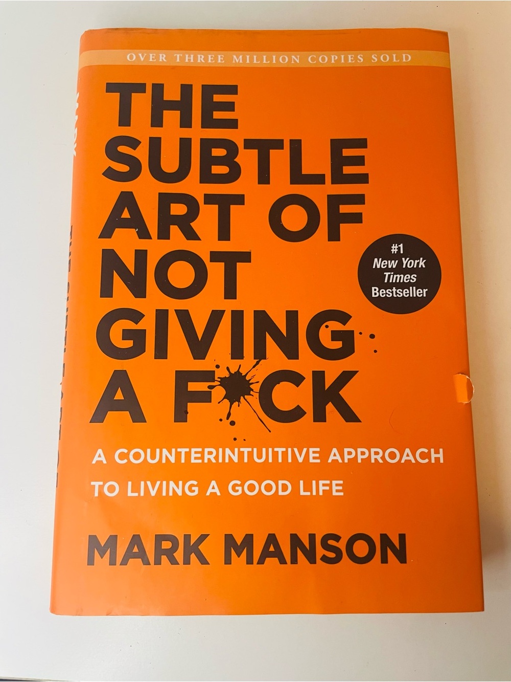 The Subtle Art of Not Giving a F*ck by Mark Manson - Bold Orange Hardcover